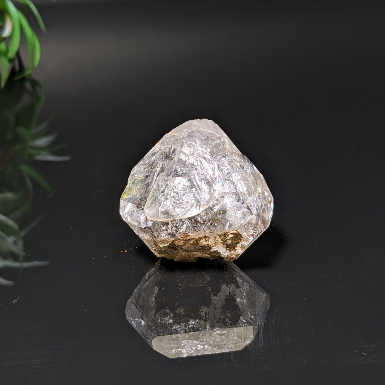 Herkimer Diamond 1.2’ Rough Point #LV4084 on black surface showcasing natural beauty