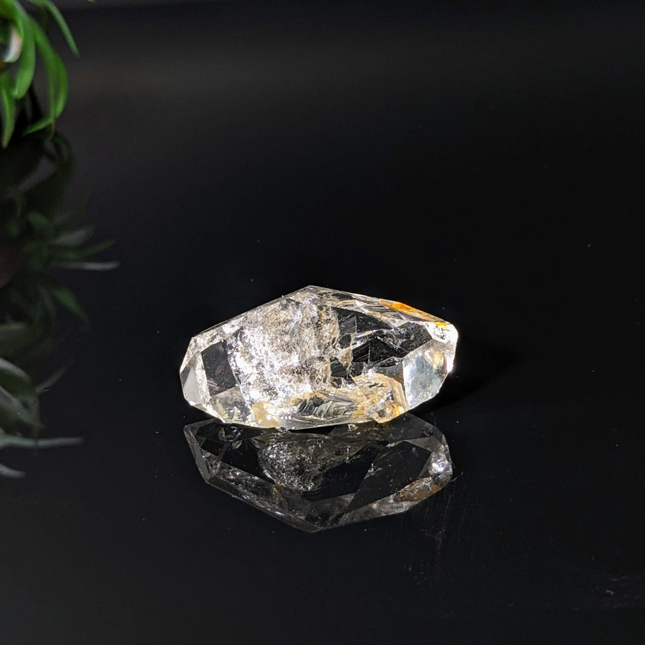 Herkimer Diamond 1.4’ rough point on black surface - Product #LV4083