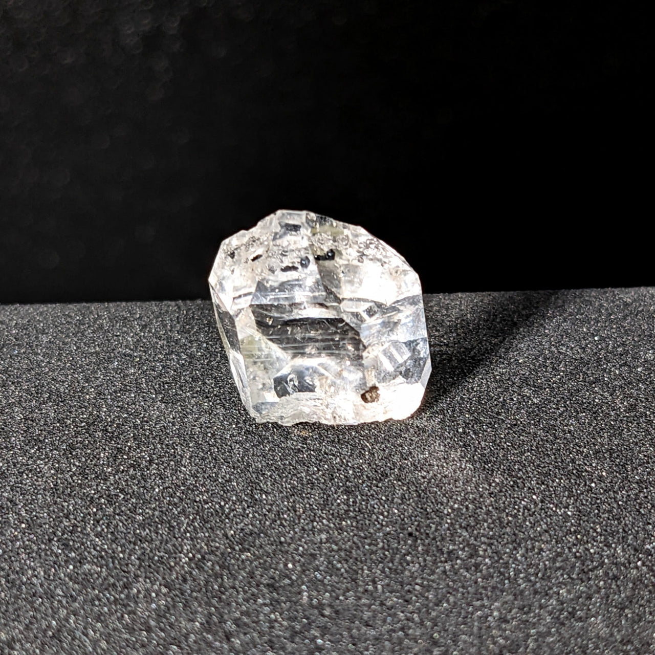 Herkimer Diamond 1.7g Point #SK9462 sparkling on a sleek black surface