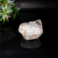 Thumbnail for A rough Herkimer Diamond 2.1’ point on a black surface, product #LV4076