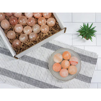 Thumbnail for Himalayan salt massage ball next to eggs and fruit on a table for natural wellness