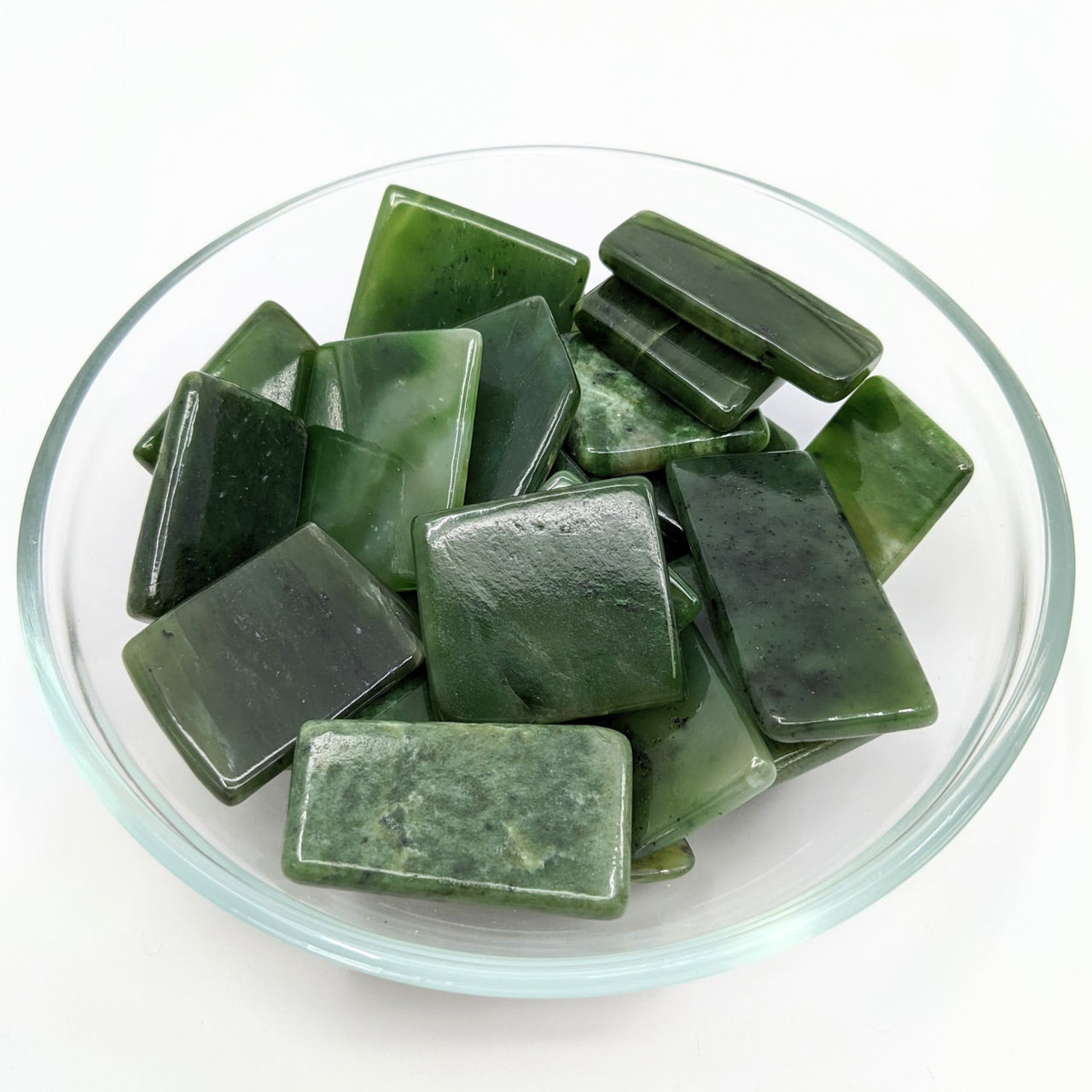 A bowl of green sea glass from the Jade Siberian 1 Slice, Assorted sizes (1.1-2.1’) #LV1261