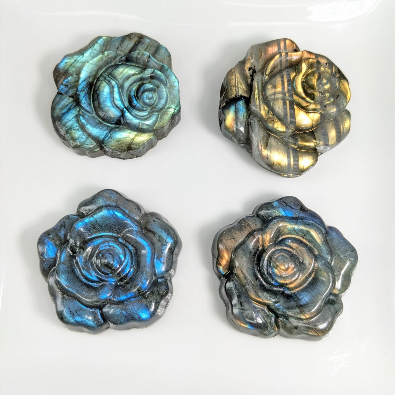 Four Labradorite blue and gold 1.3-1.5’ flower carving magnets, product #LV4149