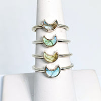 Thumbnail for Close-up of a stack of Bliss Crystals rings with labradorite mini crescent moon and colored stones