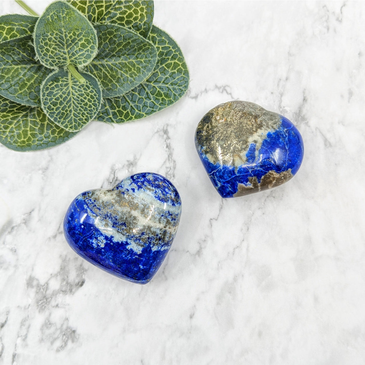 Lapis Lazuli heart glass pebbles in blue and gold on white marble background #LV5742