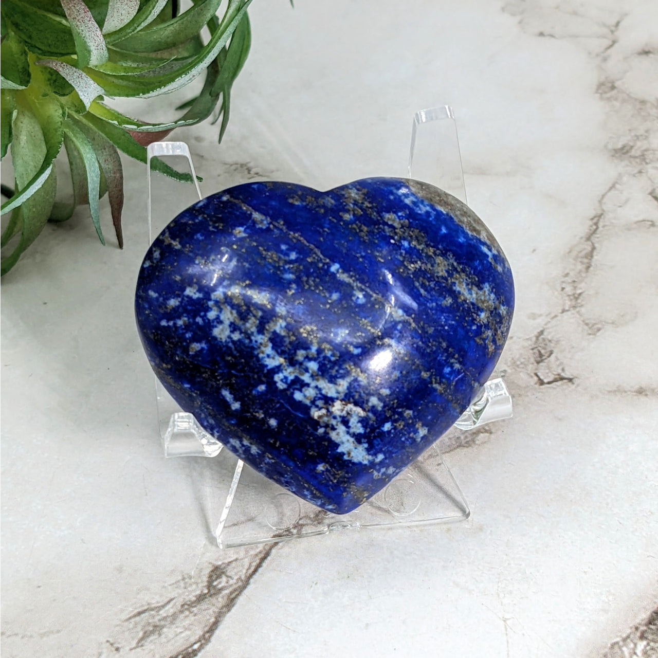 Lapis Lazuli 1.8’ Heart #LV5241: Blue heart-shaped stone on a clear stand for display