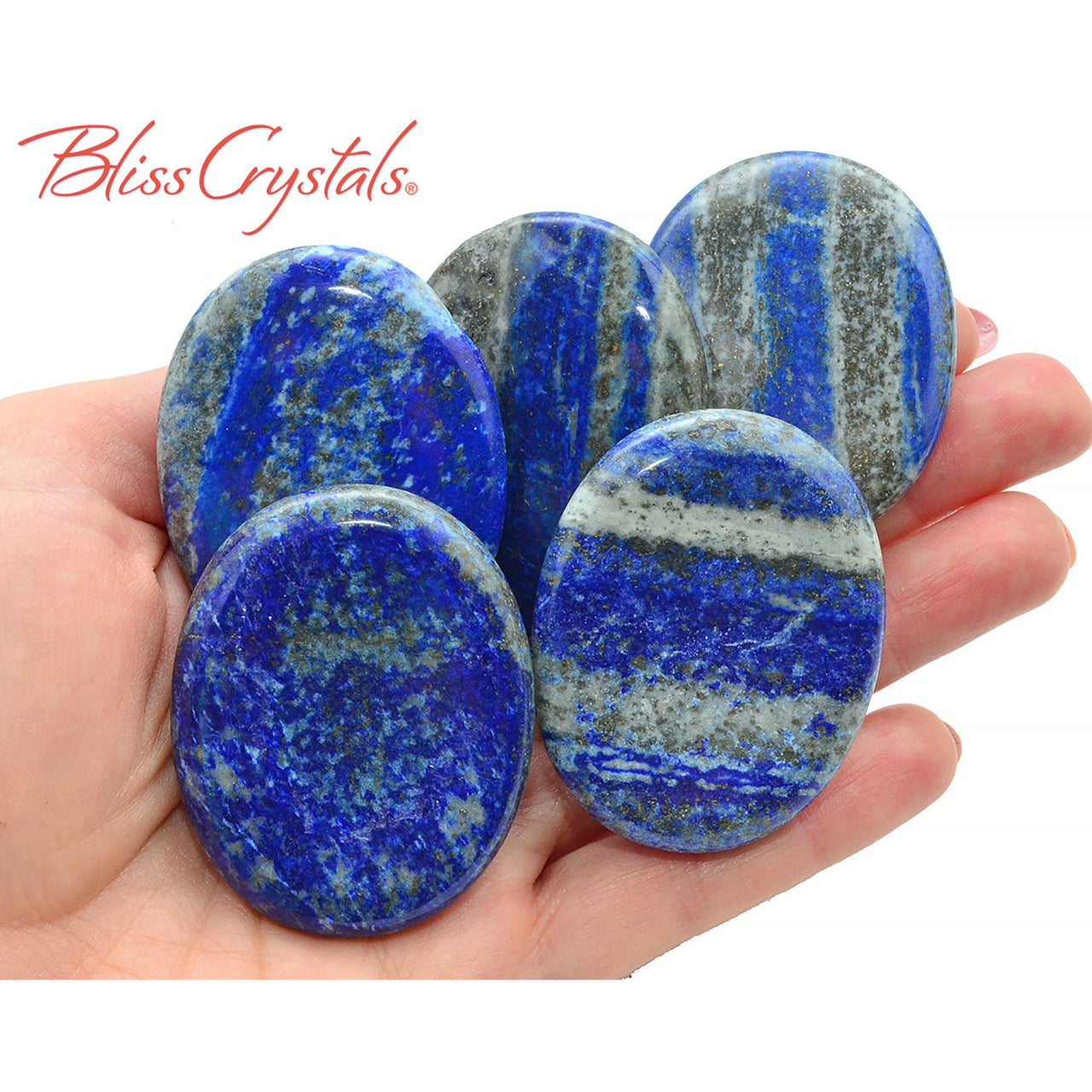 Arafed image of a person holding beautiful lapis lazuli palm stones with pyrite