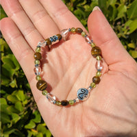 Thumbnail for Hand holding Leo Zodiac Handmade Beaded Bracelet in green and blue #LV2883