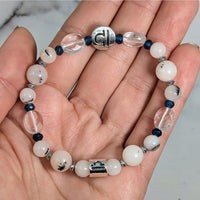 Thumbnail for Person holding Libra Zodiac Handmade Beaded Bracelet with white and blue beads, 7 inches