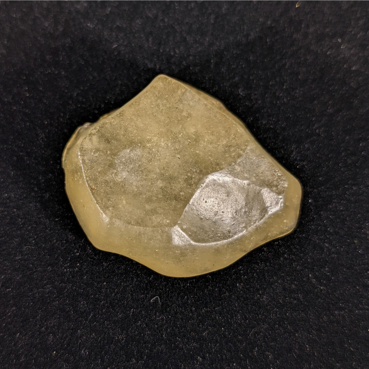 Close-up of LIBYAN DESERT GLASS Rough #R215 with a small piece on it