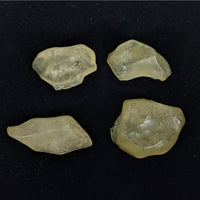 Thumbnail for Three pieces of Libyan Desert Glass on a black surface - Rough #R215, yellow quartz stones