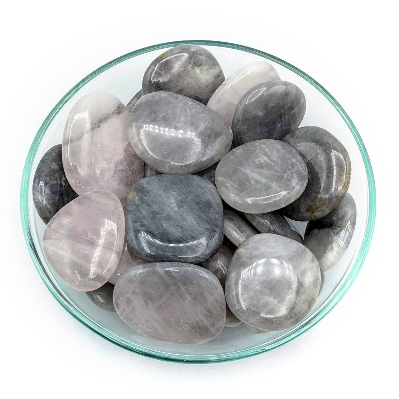 A bowl of rainbow-colored quartzs from the Luna Rose Quartz Flat Palm Stone product