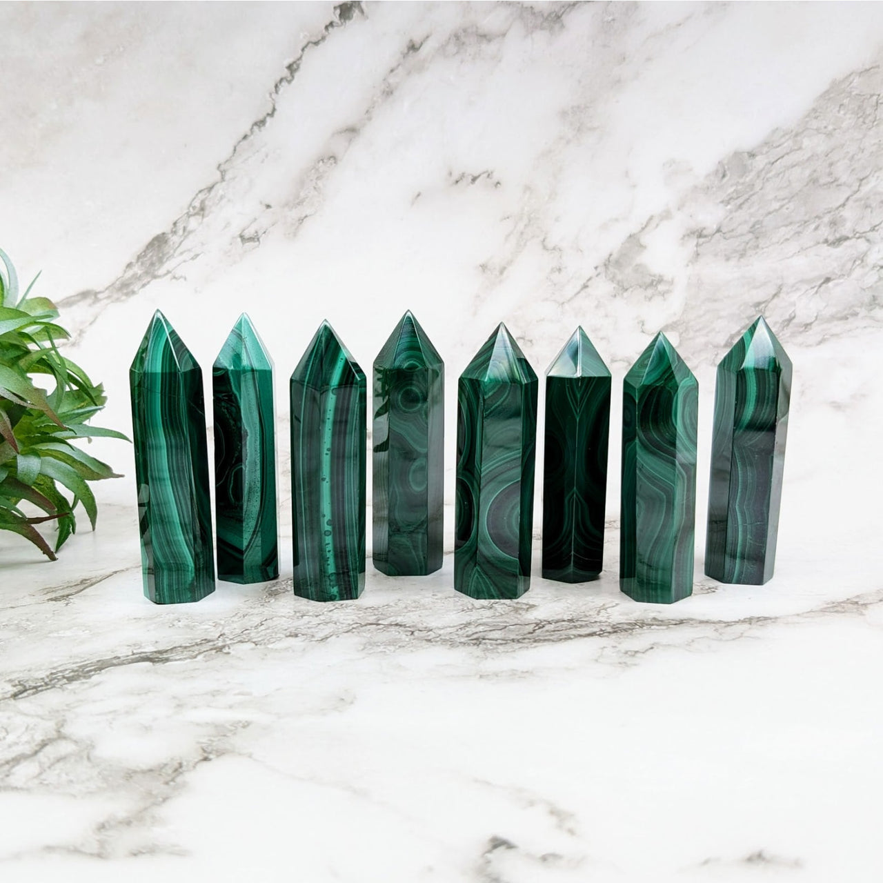 Green crystal point pens on a marble counter from the Malachite 2.5-2.6’ Tower collection