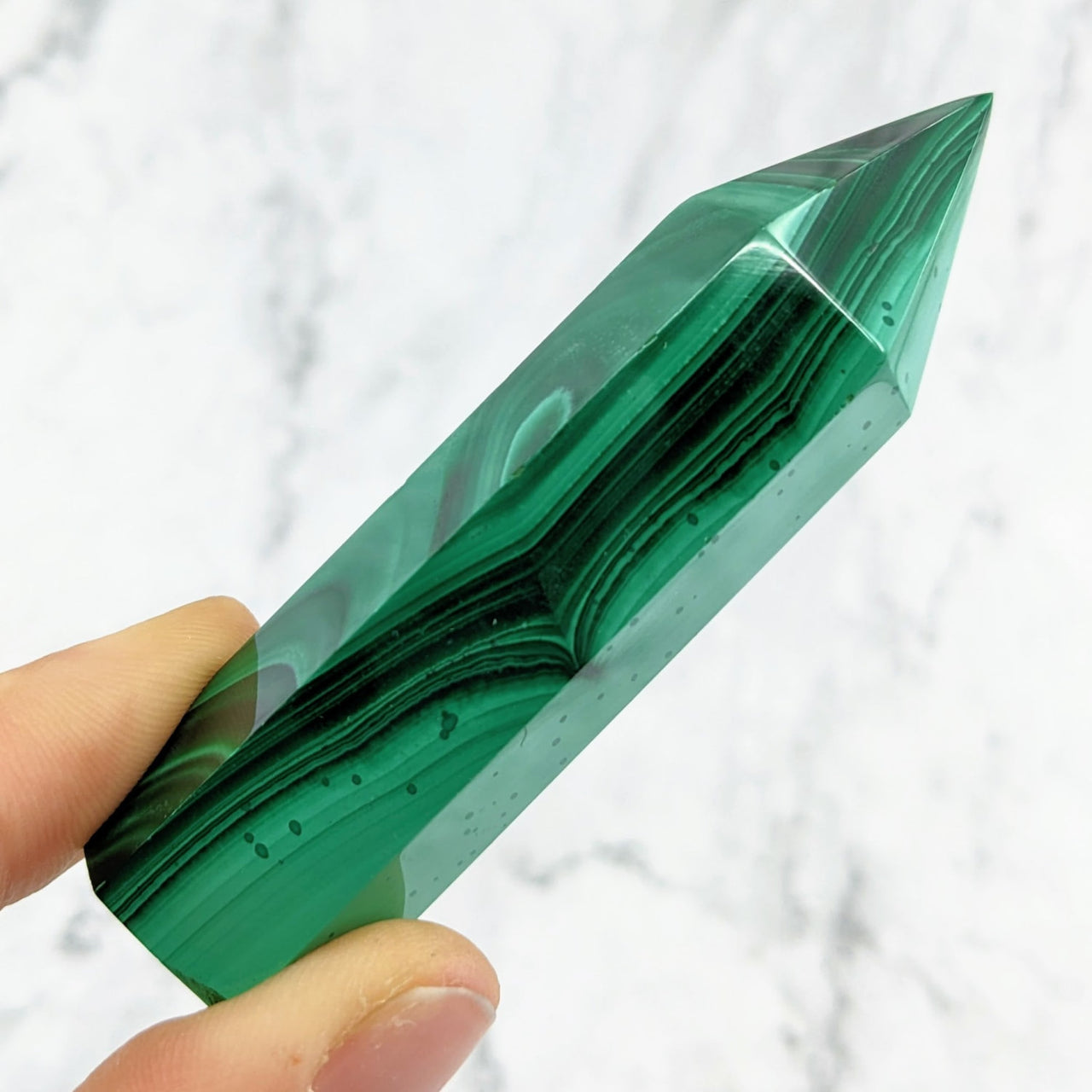 Hand Holding Green Crystal Malachite 2.7 - 3.1’ Tower #LV1460 on Marble Surface