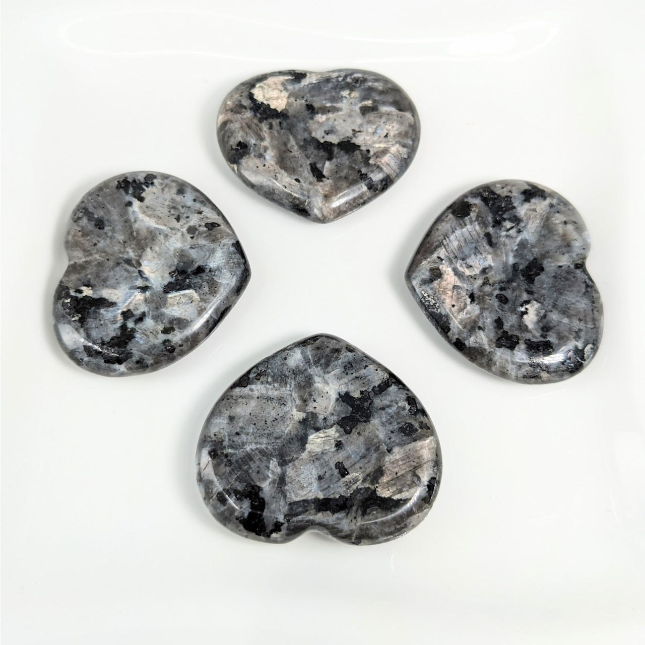 Merlinite 1.5’ Heart Thumb Stones LV4146 - Black and White Quartz on White Plate