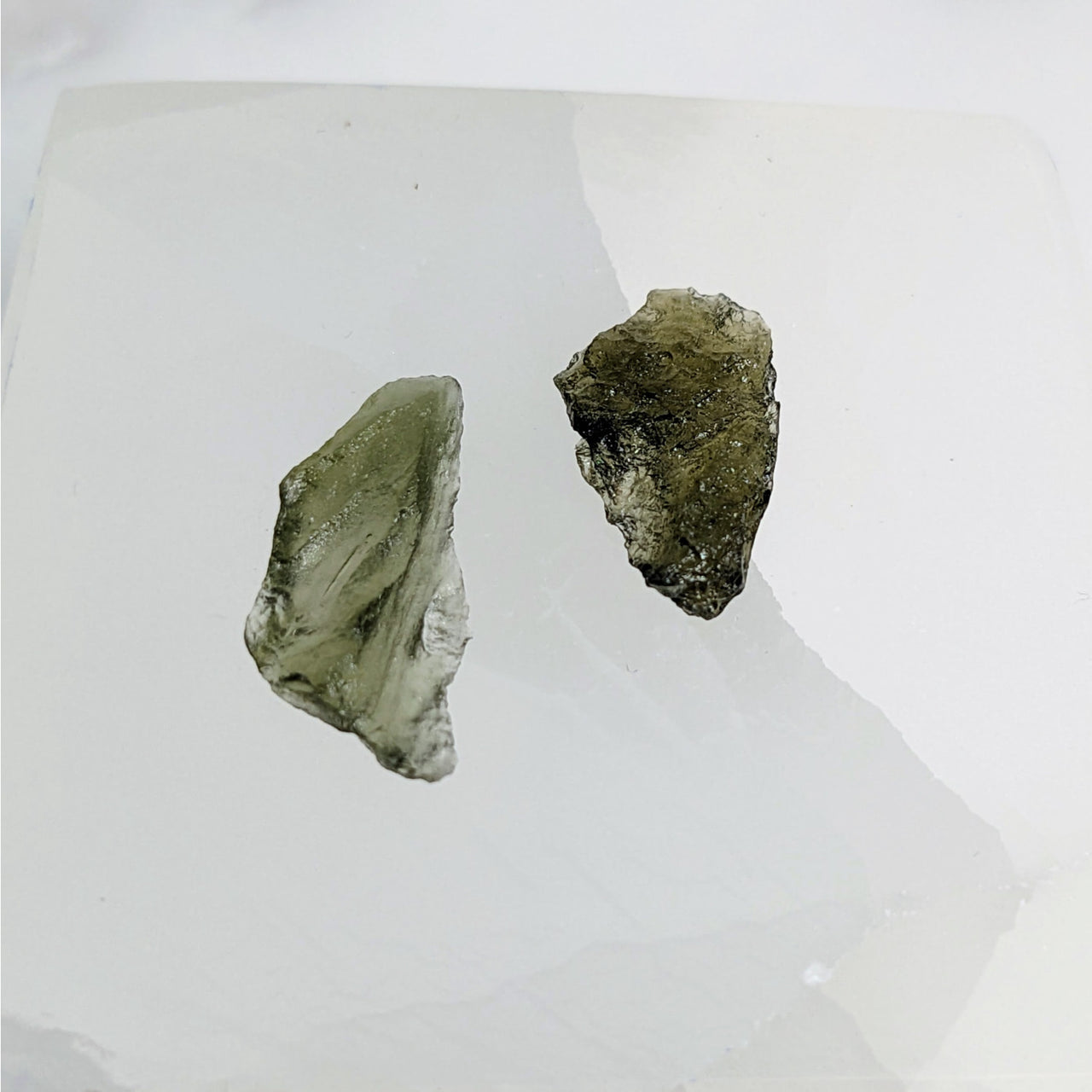 Moldavite Raw .47-.48gm Chunk Czech Republic #LV3467 - Two Pieces on White Surface