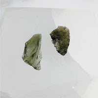 Thumbnail for Moldavite Raw .47-.48gm Chunk Czech Republic #LV3467 - Two Pieces on White Surface