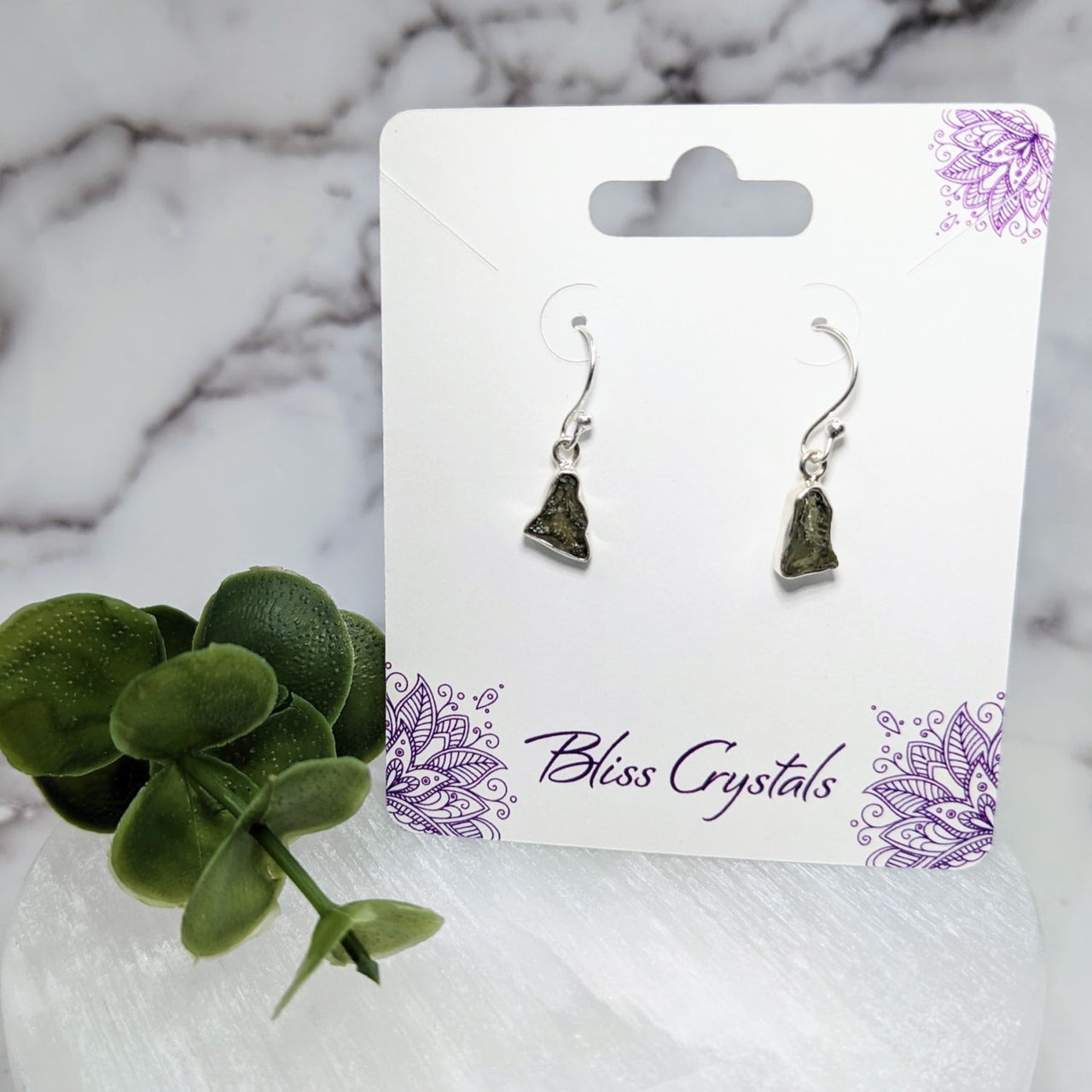 Silver bell earrings on white marble table - Moldavite Rough S.S. Earrings #LV3968