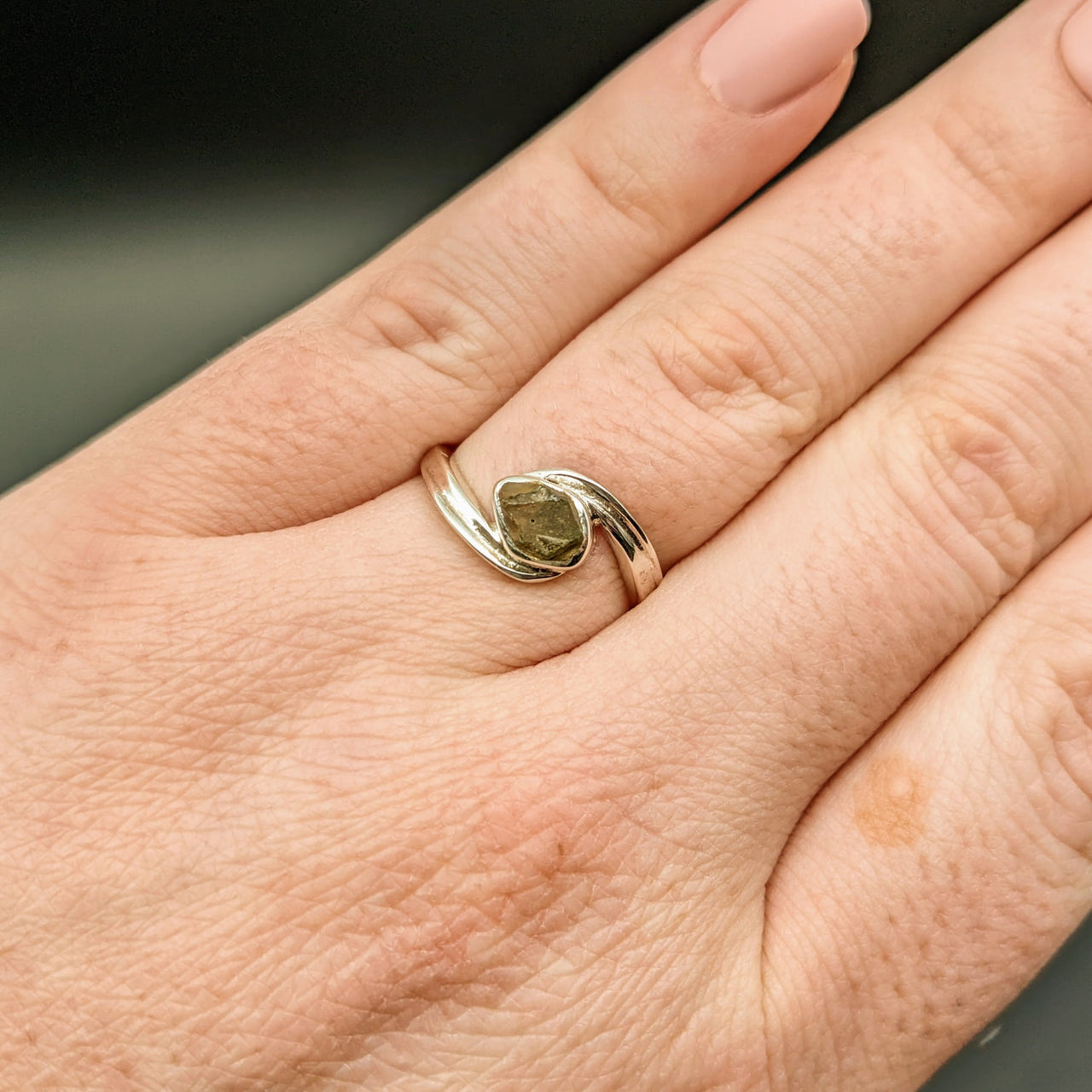 Woman’s hand with Moldavite Sterling Silver Swoop Ring #SK2626