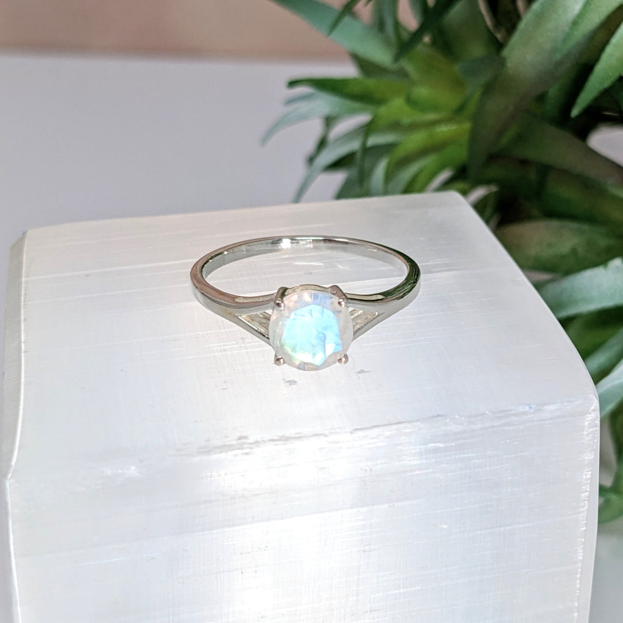 Moonstone Faceted Round Gem Ring #LV2788 resting on a white block with a white stone centerpiece