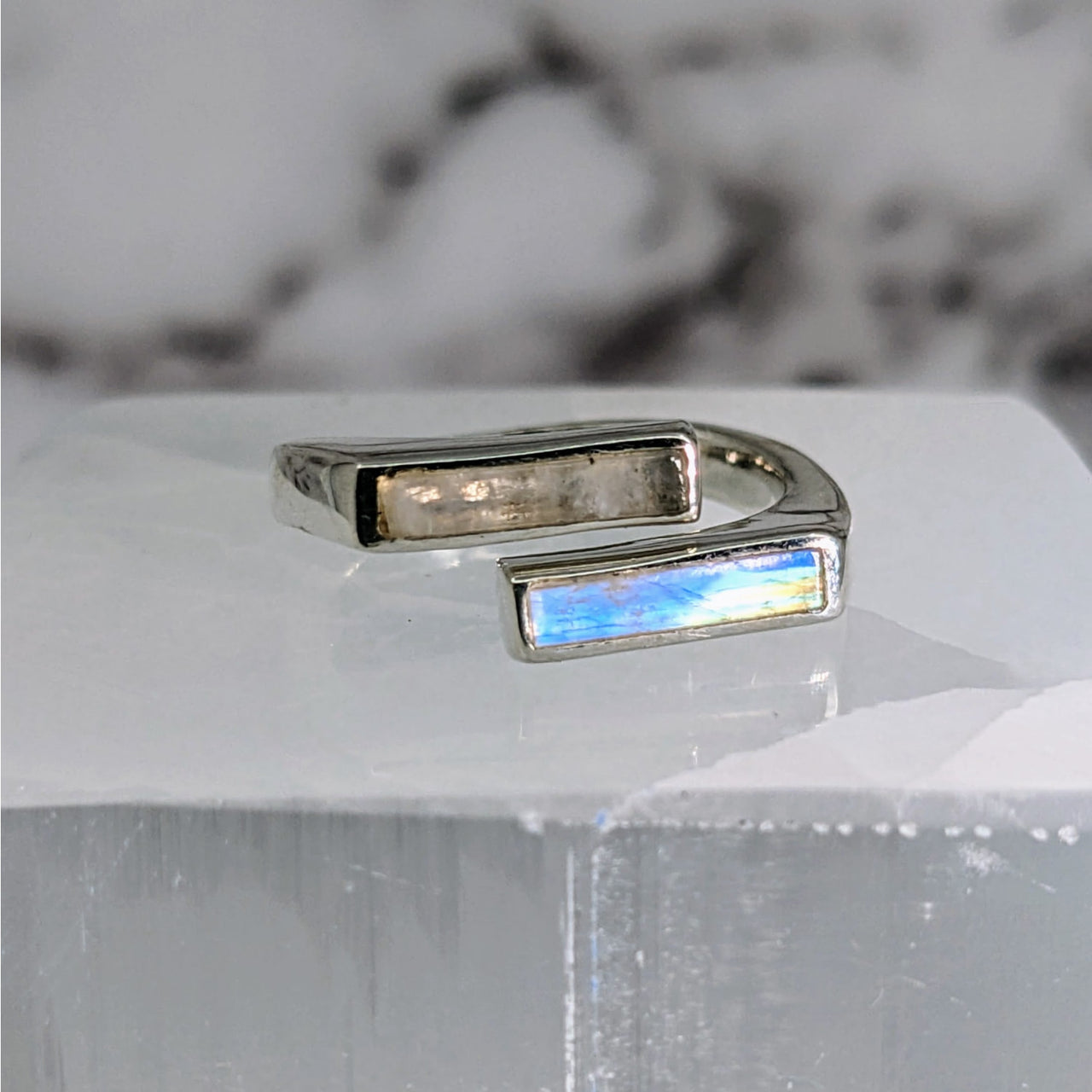 Moonstone S.S. Split Bar Ring #LV3878 with Blue Stone on White Surface