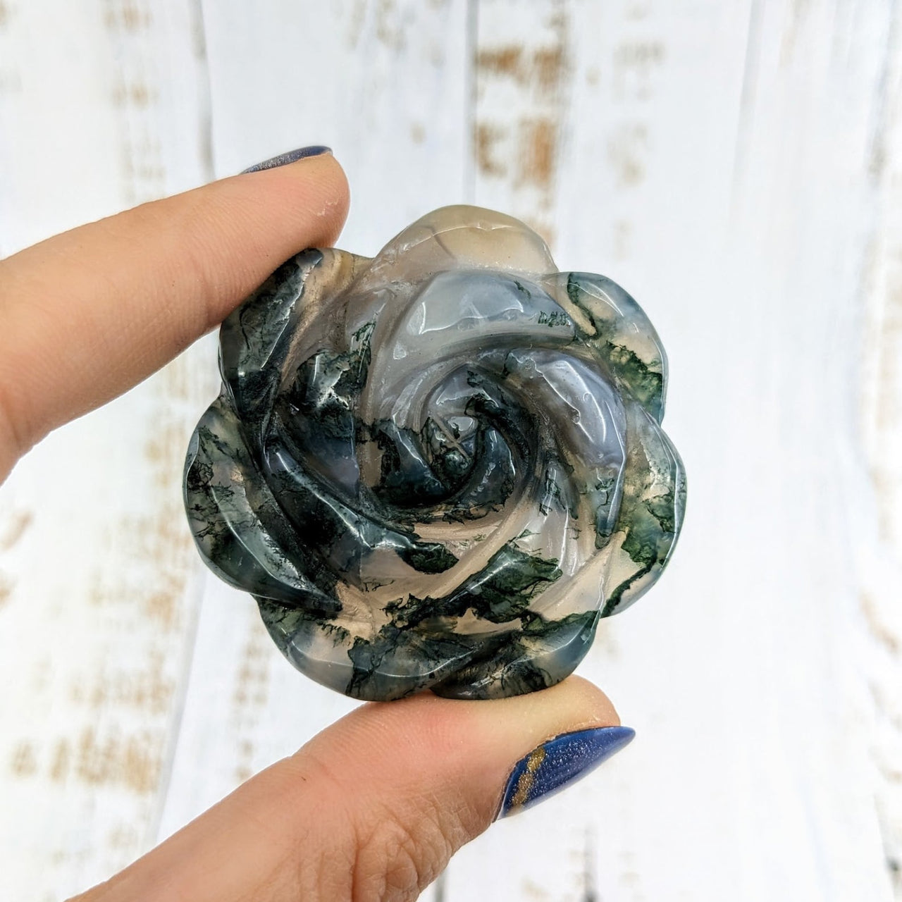 Hand holding Moss Agate 2.1’ Flower Carving LV1977