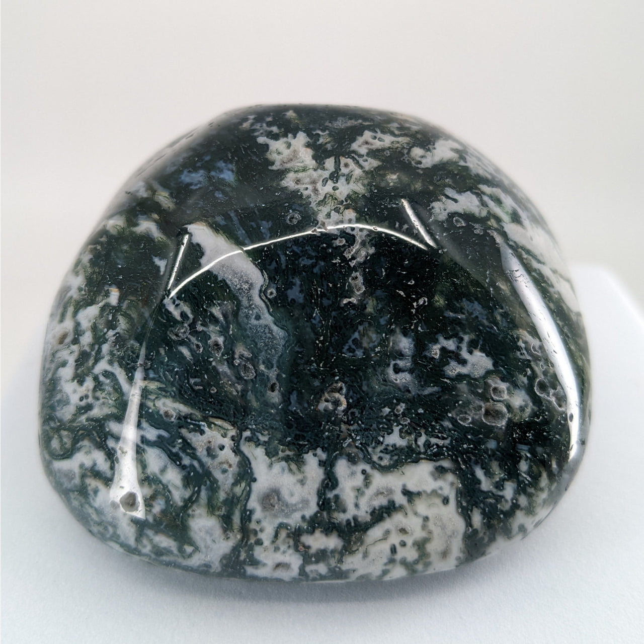 Moss Agate Touchstone P165: Black and white stone on white background