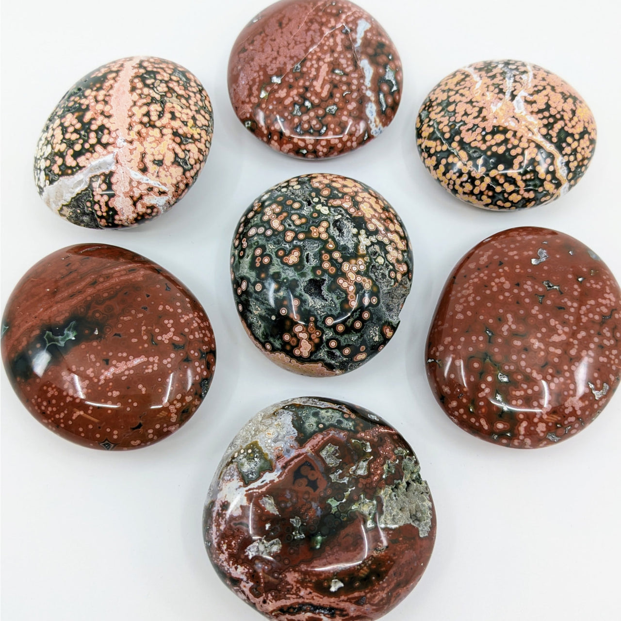 A selection of chocolates displayed beside Ocean Jasper Pebble Choose Size #LV3168