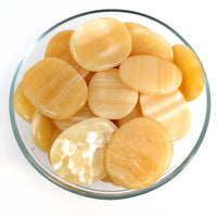 Thumbnail for Sliced potatoes in a bowl next to Orange Calcite Palm Stones for sale