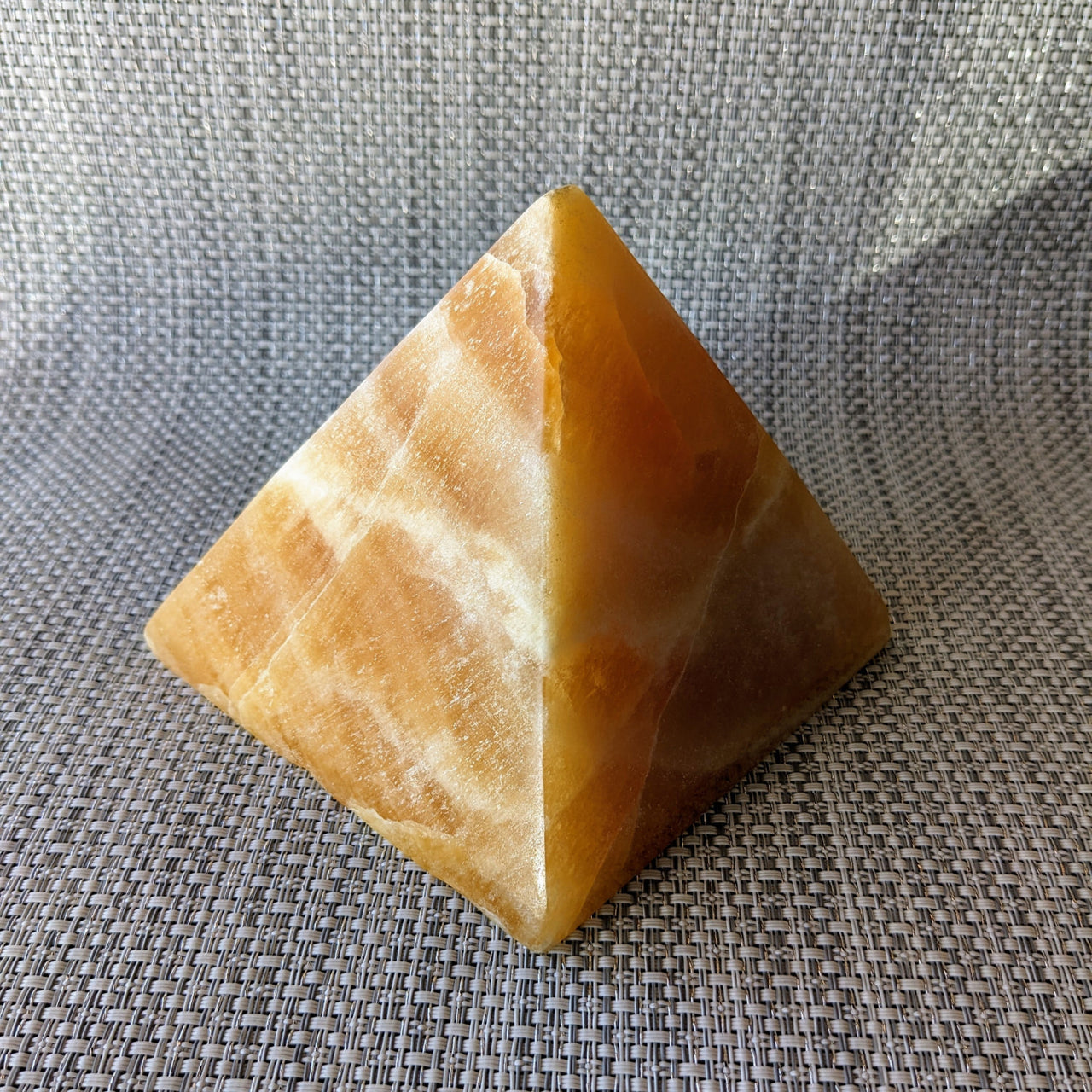 Orange Calcite 4.3’ Pyramid #LV5430 - yellow stone pyramid on gray background