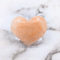 Thumbnail for A heart-shaped Himalayan stone on a marble table, Peach Selenite 2.1’ Heart #LV4133