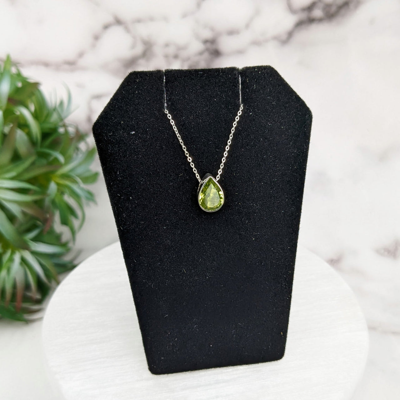 Peridot Faceted Necklace in Sterling Silver on Display with Plant Background - 18’ Chain #LV3256