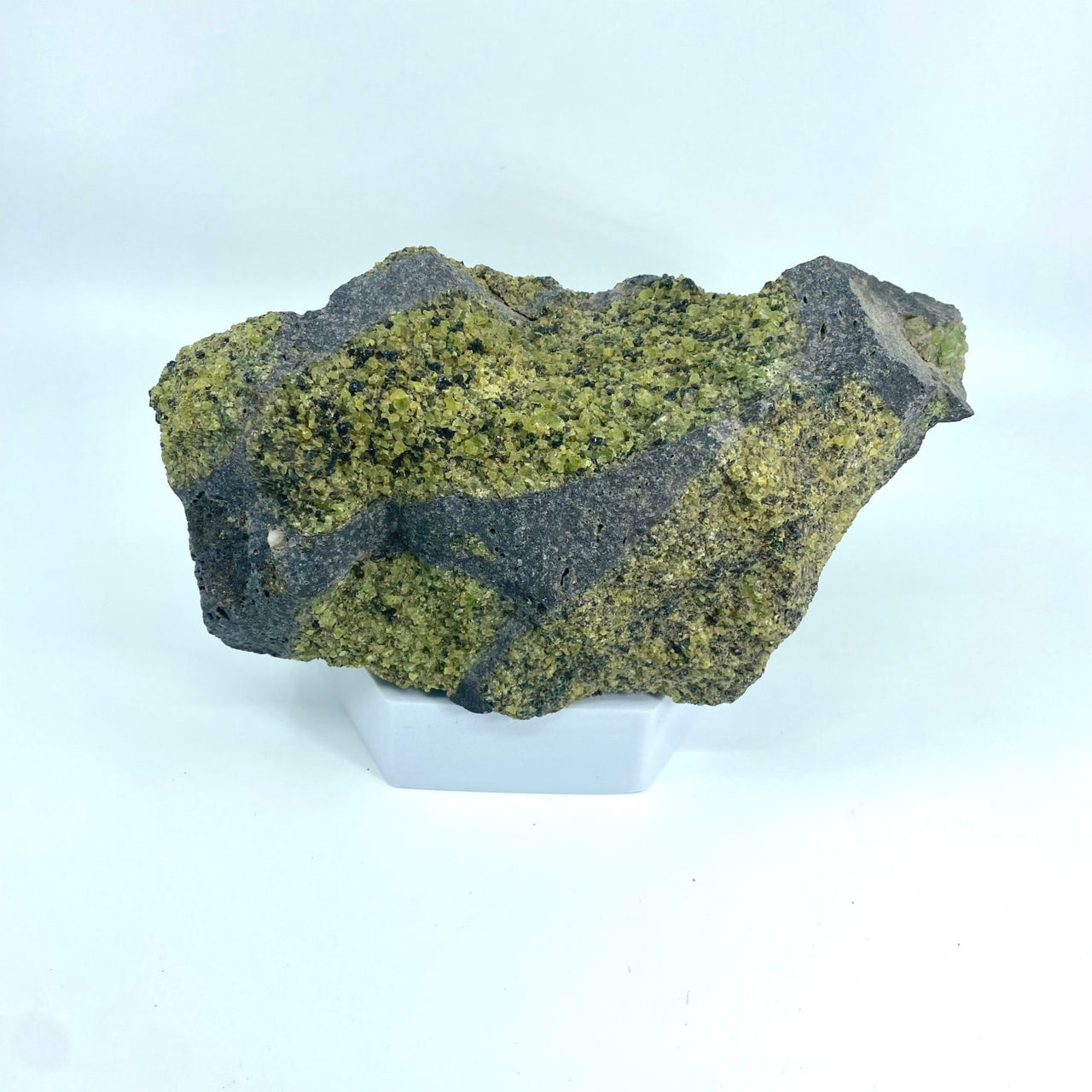 Peridot Rough Specimen Arizona #M120 featuring a rock with lush green moss growth