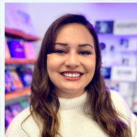 Thumbnail for Woman with long brown hair in white sweater during a natal chart session with Devin