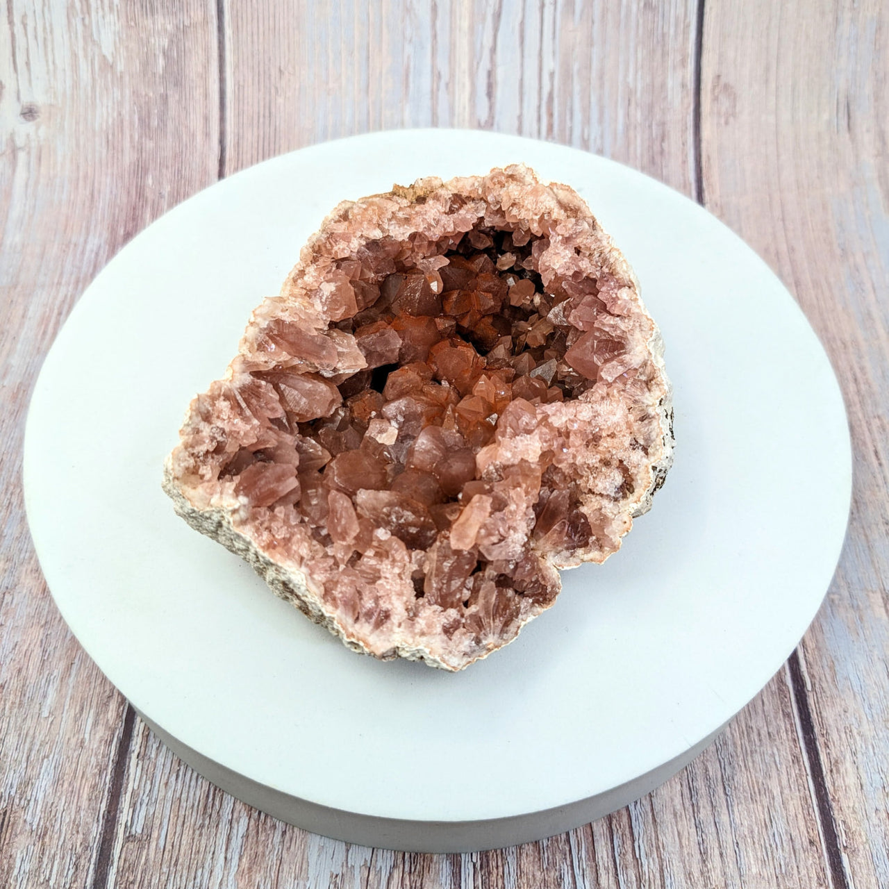 Pink Amethyst 4’ Rough Geode Specimen #SK9905 on a white plate with chocolate chunks