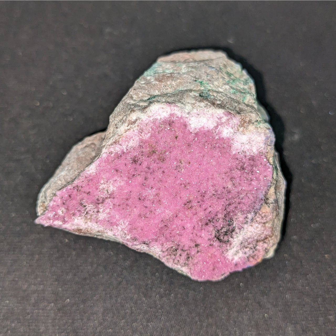 A close-up of Pink Cobaltian Calcite Rough #SK5950 mineral, showcasing its pink and green hues