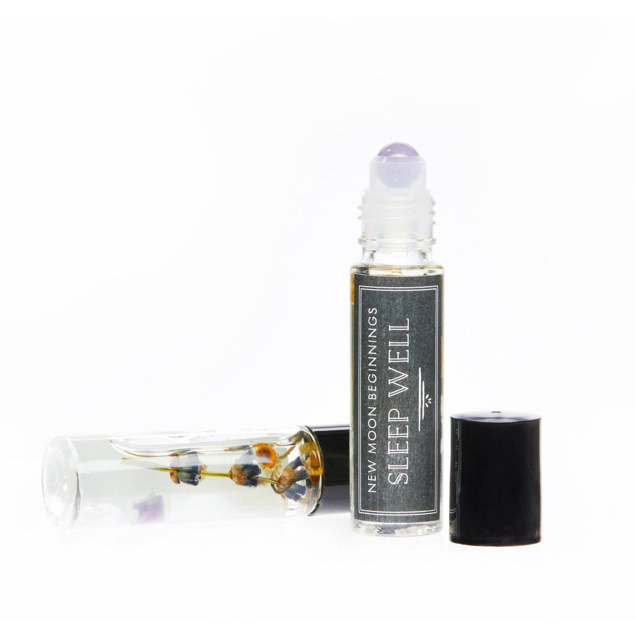 Bottle of lavender essential oil with a small glass vial for Positive Energy Roll-on perfume