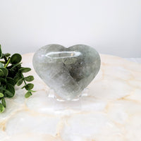 Thumbnail for Heart-shaped quartz stone on white marble table from Prasiolite Jumbo Heart #LV4855