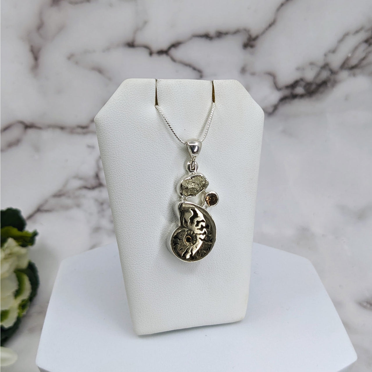 Sterling silver necklace with pyritized ammonite and smoky quartz pendant promoting positive energy