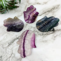 Thumbnail for Rainbow Fluorite Hamsa #LV4224 with three amethyst crystals on a marble table