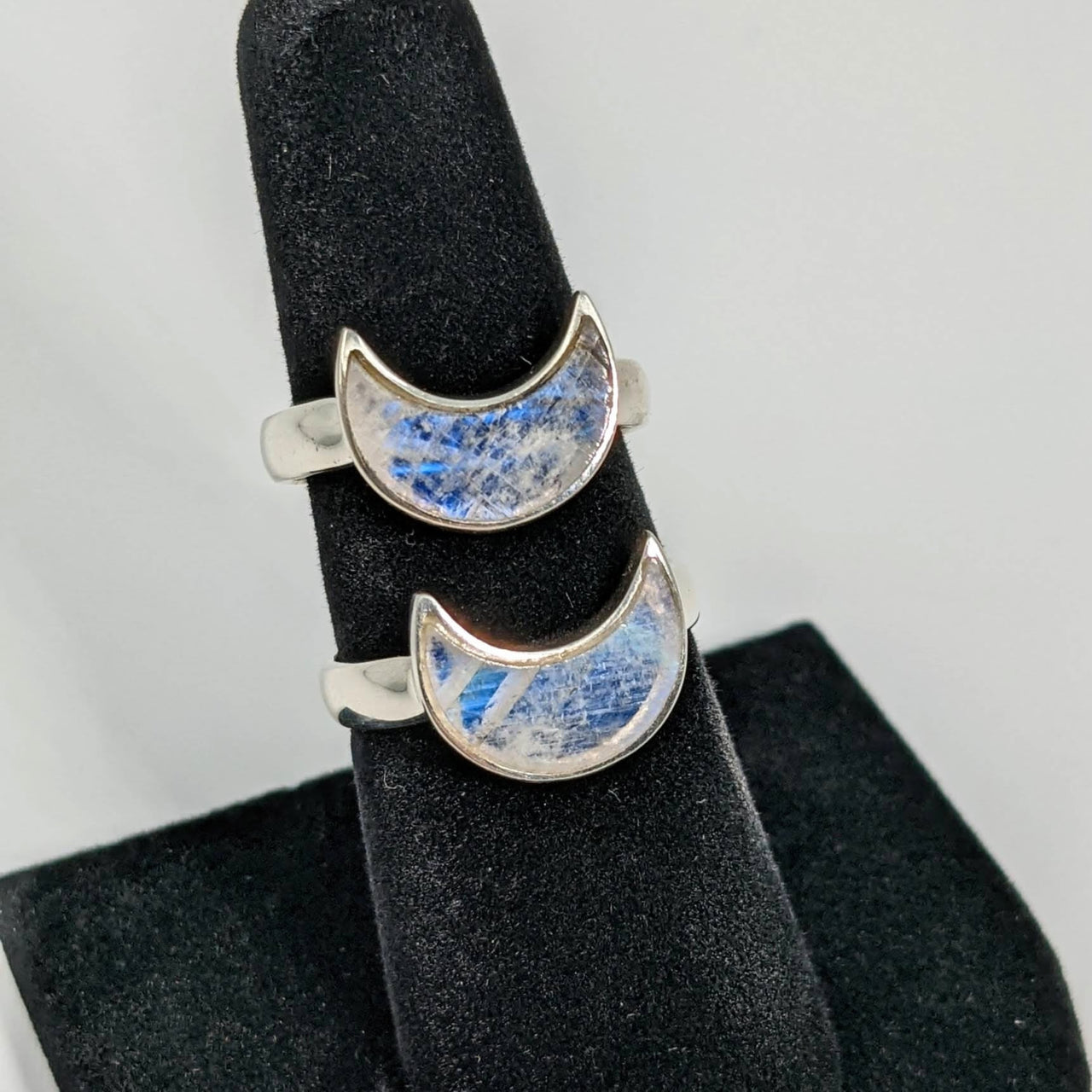 Pair of Rainbow Moonstone Crescent Moon Sterling Silver Rings with blue and white marble