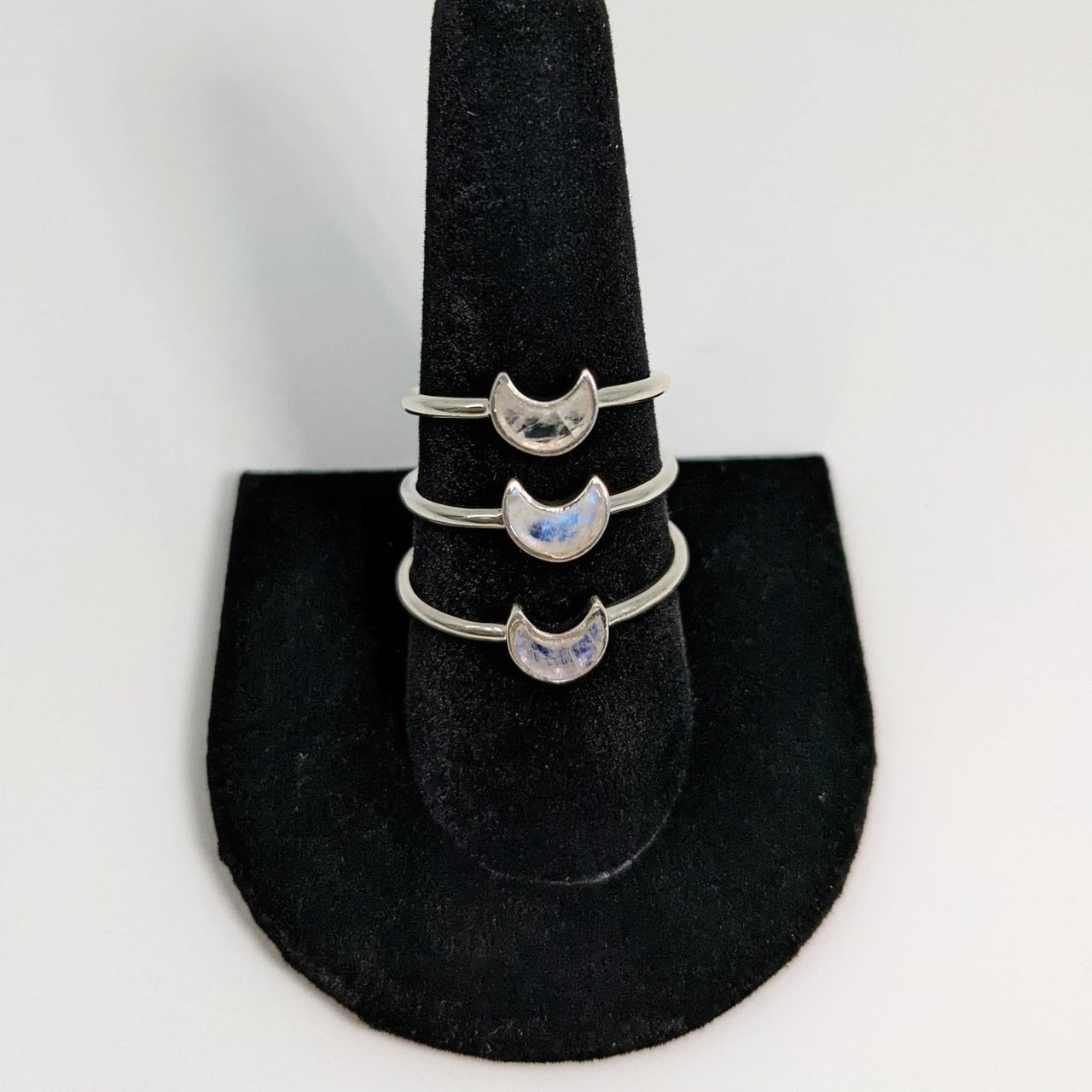 Close up of Rainbow Moonstone Mini Crescent Moon Ring #SK6667 on black hat with cat