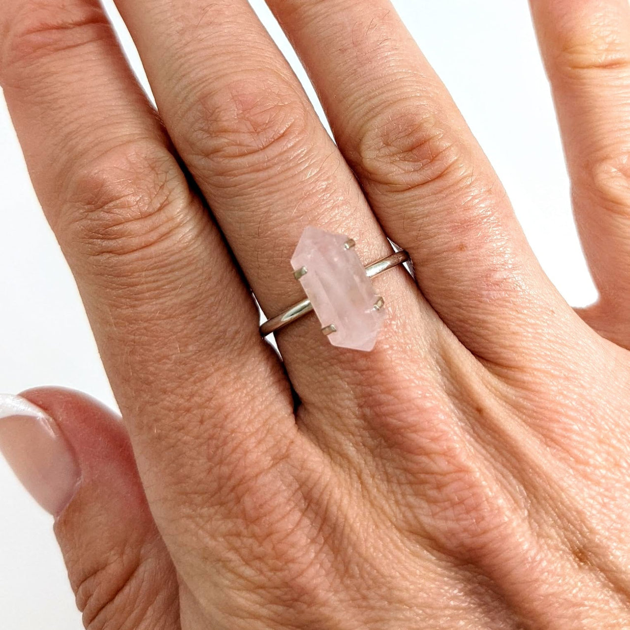 A woman’s hand with a Rose Quartz Sterling Silver Ring #SKU6904