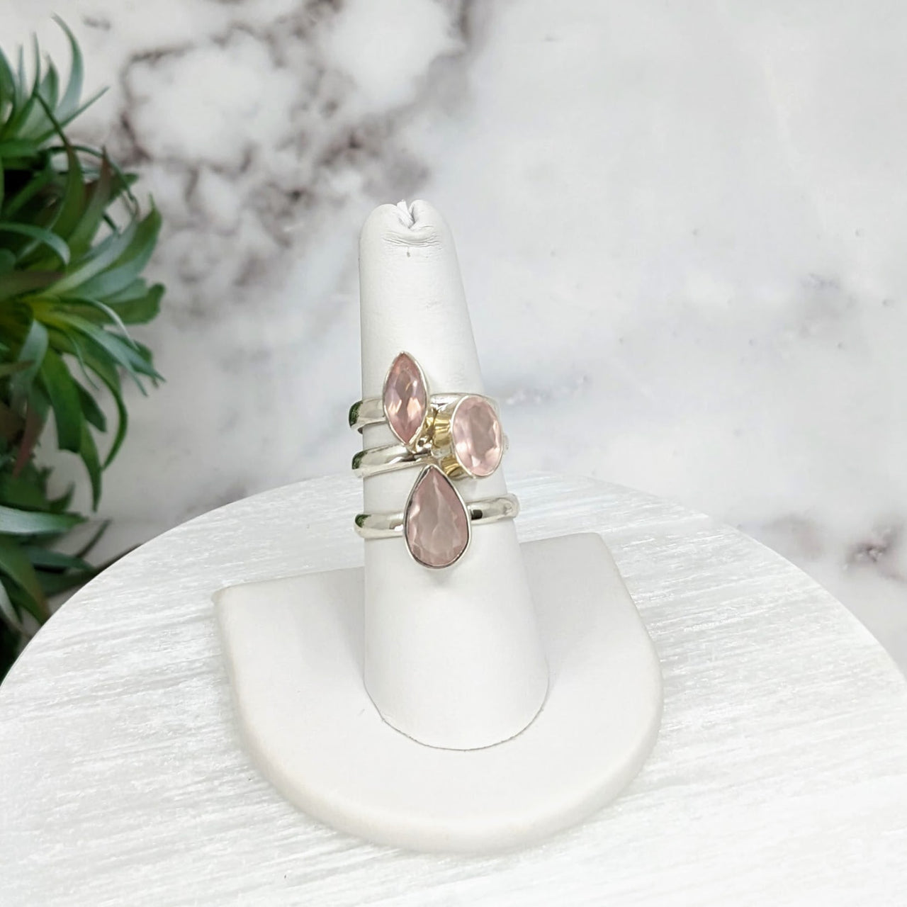 Rose Quartz Faceted Sterling Silver Ring on a white marble table