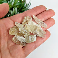 Thumbnail for Hand holding green kunzite 30gm parcel mixed sizes with clear quartz crystals