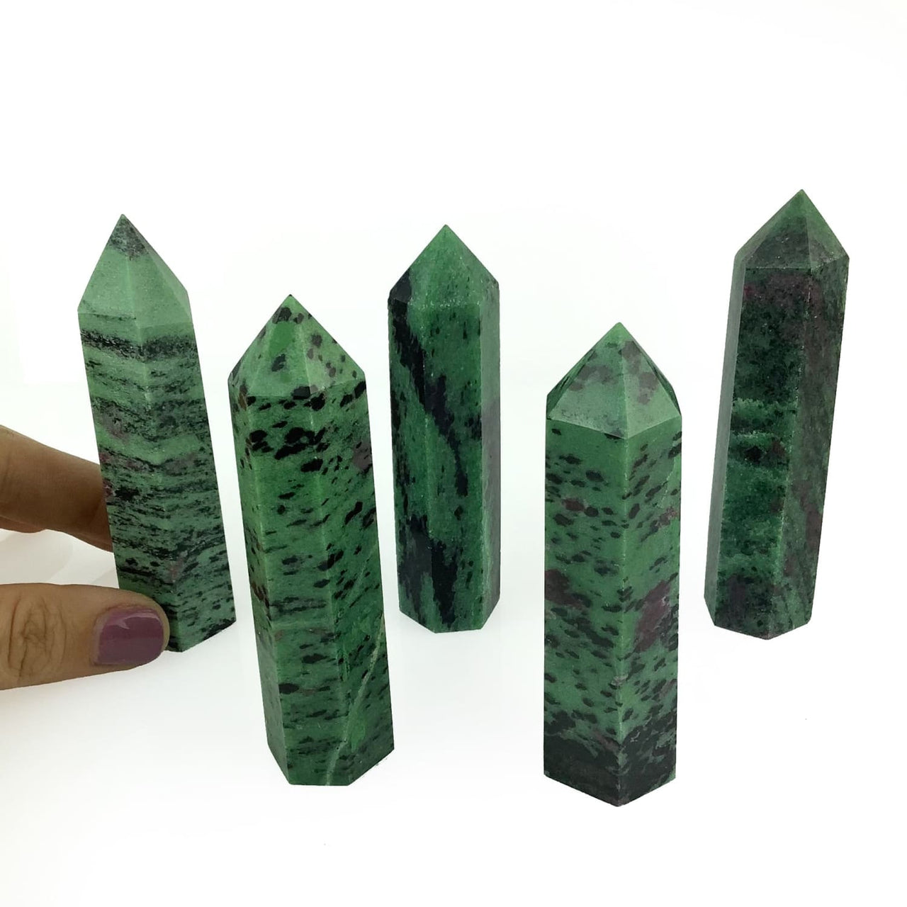 A hand holding a green quartz point product named Ruby Zoisite EQ Tower #G074