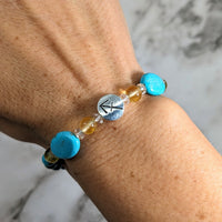 Thumbnail for A woman’s hand with Sagittarius Zodiac Handmade Beaded Bracelet in turquoise and yellow beads