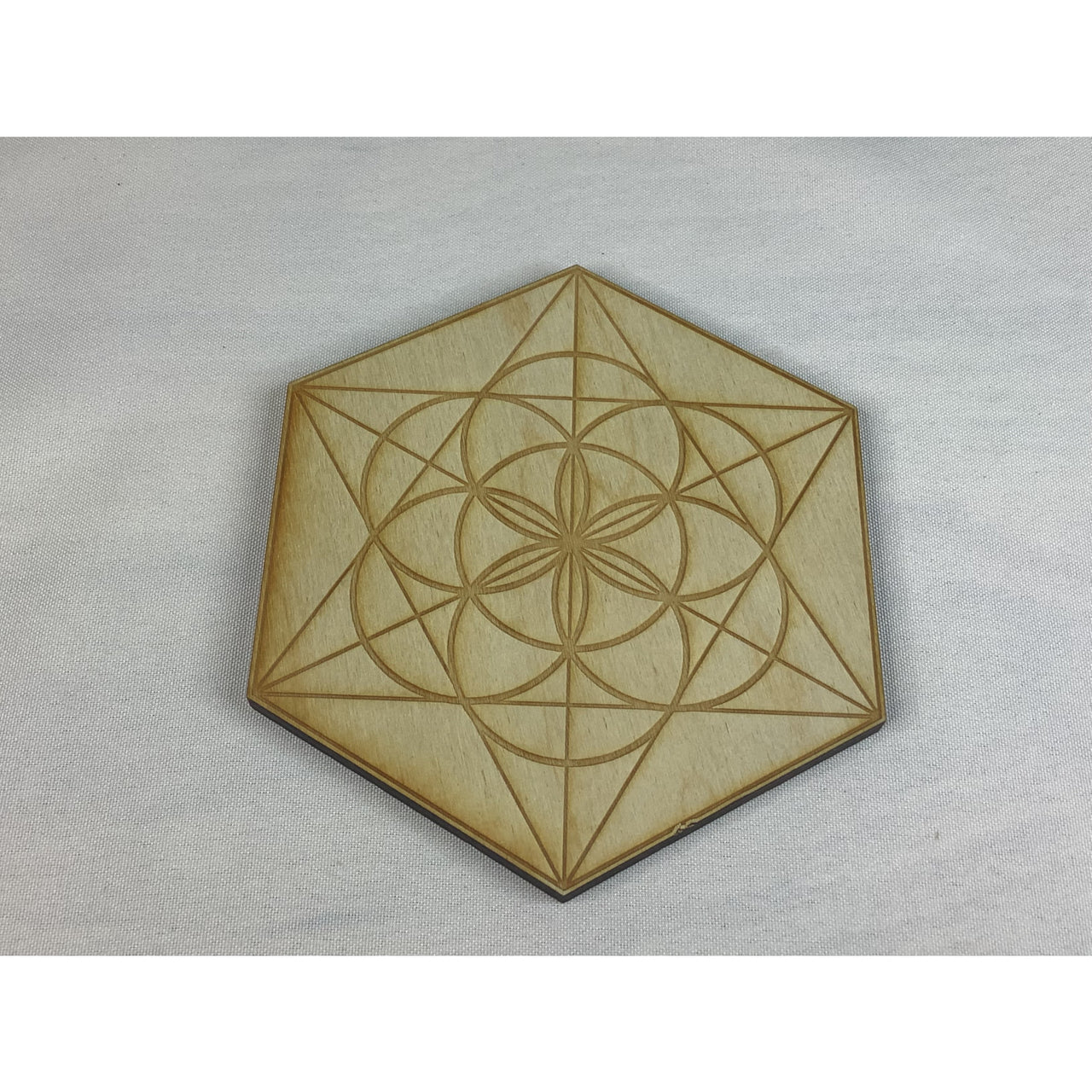 Seed of Life Etched Alder Wood Grid #K148: Intricate geometric design on a wooden badge