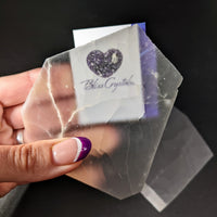 Thumbnail for Person holding clear quartz piece from Selenite TV Rock Rough product, SKU #SK8746