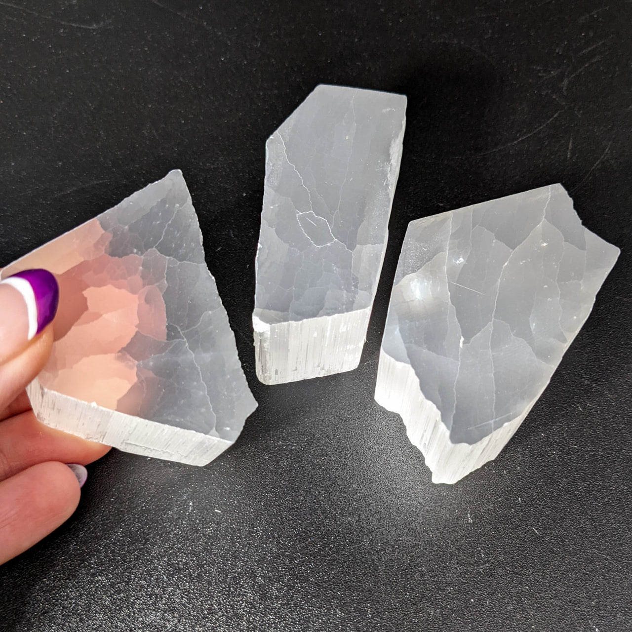 Clear quartz crystals on black background, part of Selenite TV Rock Rough #SK8746